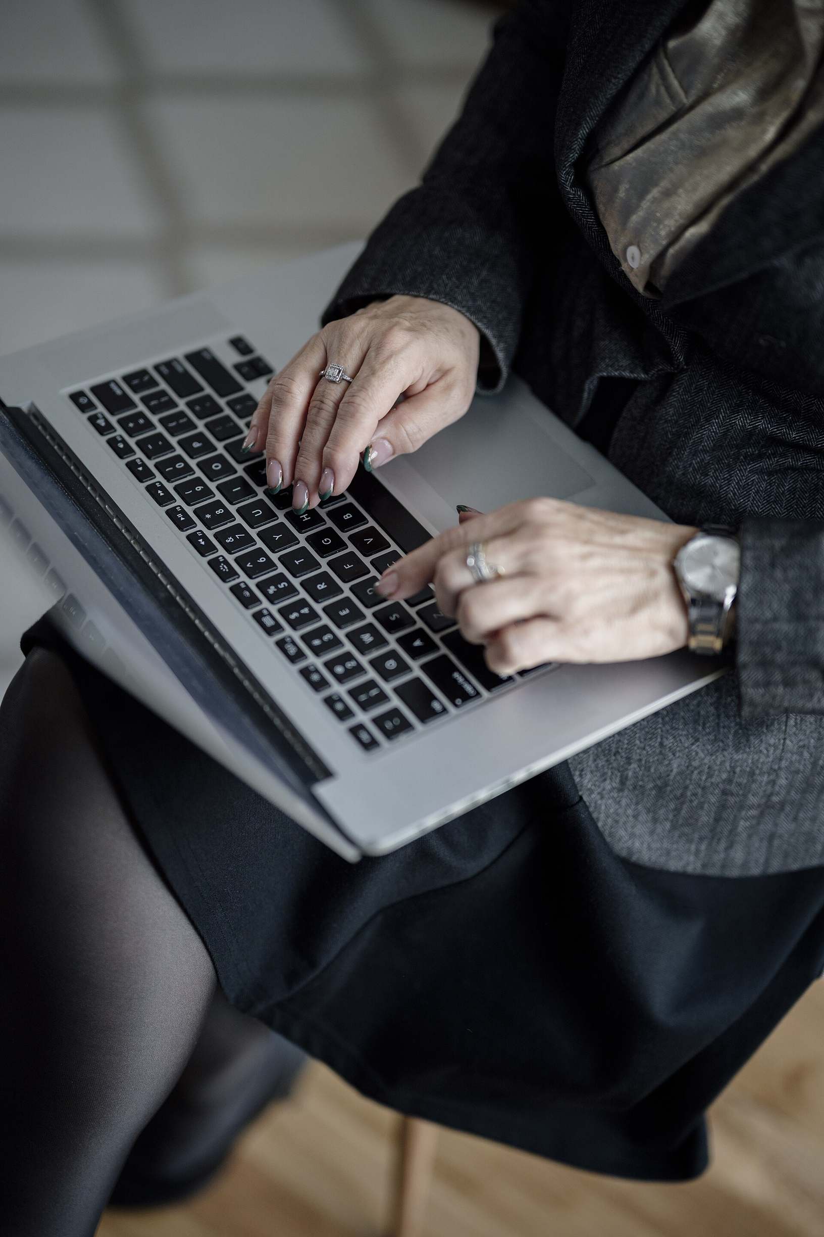 Developer hands on a laptop during a backend coding session in a bright office